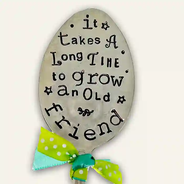It Takes A Long Time To Grow An Old Friend flattened silver-plate spoon garden marker