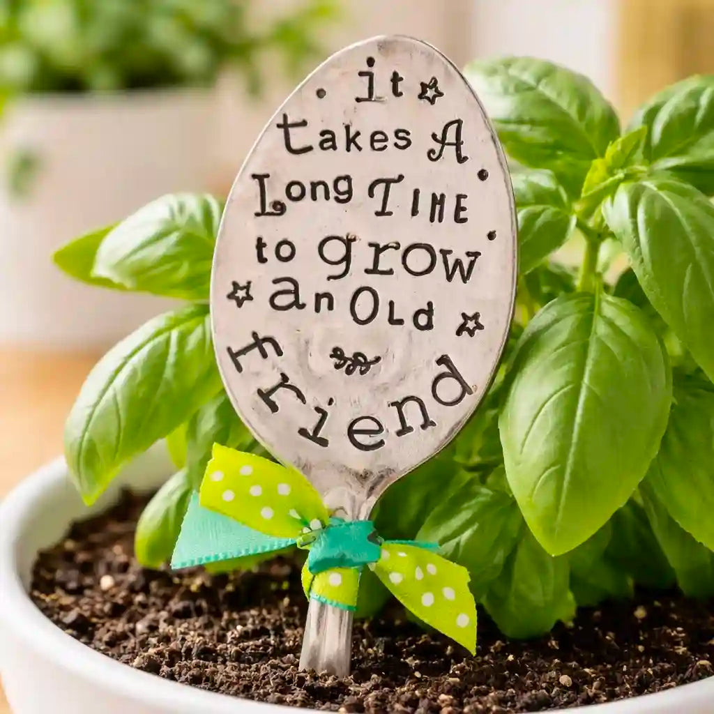 Decorative spoon with engraved text in a potted plant