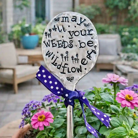 Garden marker made from a spoon with text stamped on it.