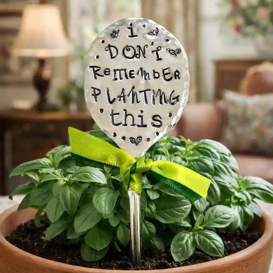 Decorative spoon with 'I Don't Remember Planting This' text in a potted plant with a green ribbon.