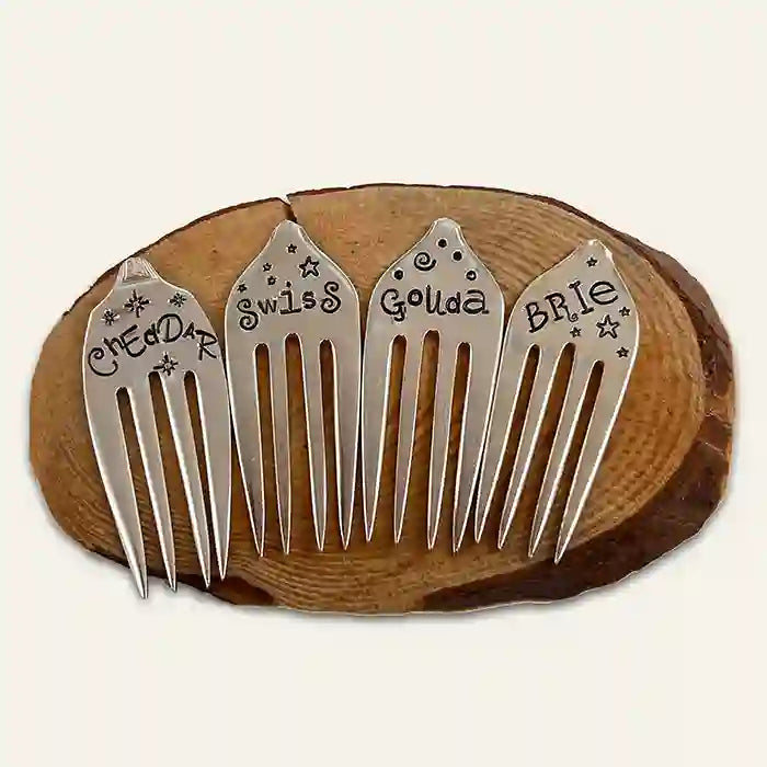 Gouda, cheddar, brie, and swiss silverware fork cheese markers on wood coaster