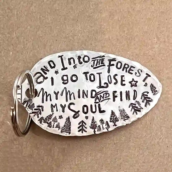 And Into The Forest I Go To Lose My Mind & Find My Soul silver-plate spoon keychain on wood