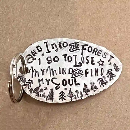 And Into The Forest I Go To Lose My Mind & Find My Soul silver-plate spoon keychain on wood