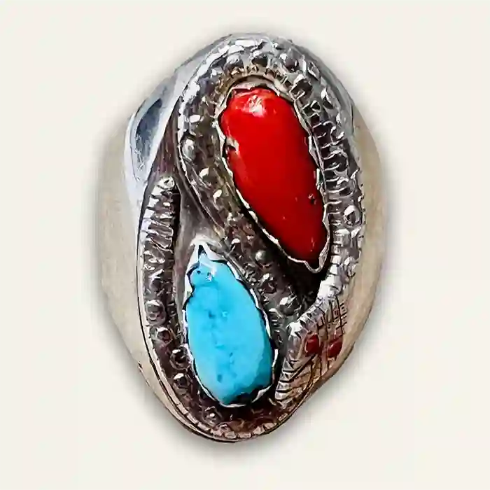 Sterling Silver snake ring with imbedded red coral and blue turquoise stones on white background
