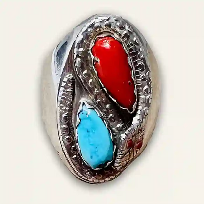 Sterling Silver snake ring with imbedded red coral and blue turquoise stones on white background
