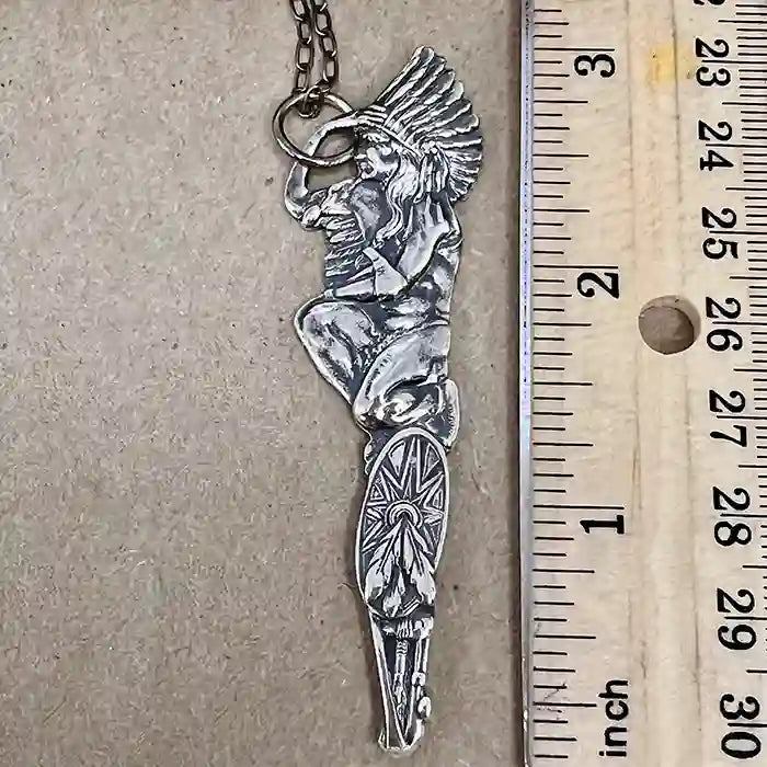 Silver-plate pendant of a stylized Native American figure made from a vintage souvenir spoon handle measuring nearly 4 inches