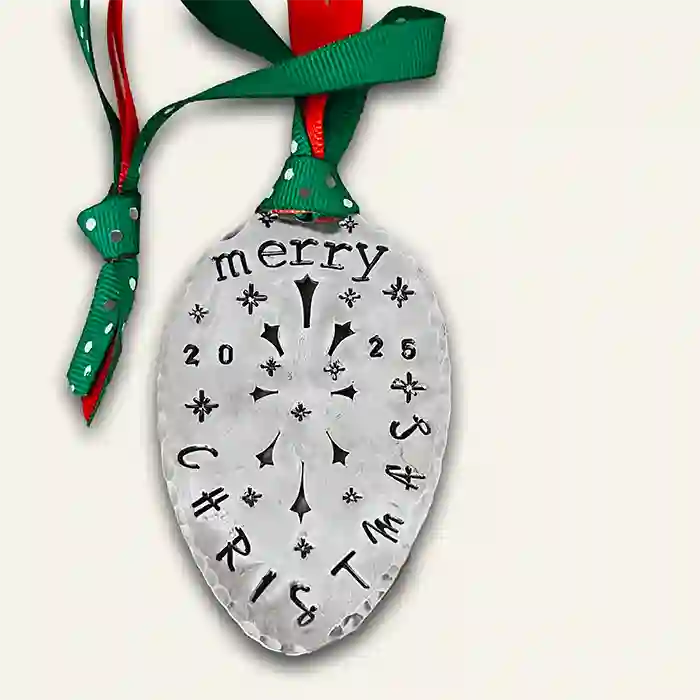 Vintage silver-plate slotted serving spoon with 2025 Christmas stamped on it