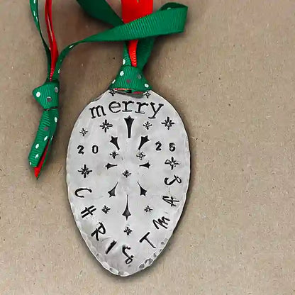 Vintage silver-plate slotted serving spoon with 2025 Christmas stamped on it and green and red ribbon