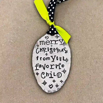 Merry Christmas From Your Favorite Child vintage silver-plate spoon ornament on dark background