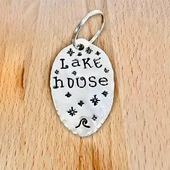 Lake House Silver-plate vintage spoon keychain on wood background