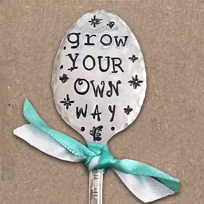 Grow Your Own Way flattened silver-plate spoon garden marker on brown background