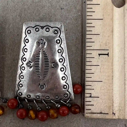 southwest sterling silver earrings by a ruling showing length at 1.5 inches.