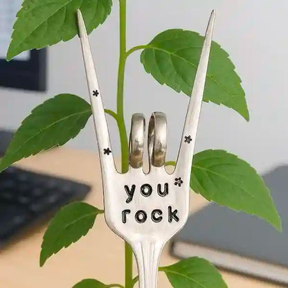 You Rock fork garden marker by a tall thin plant
